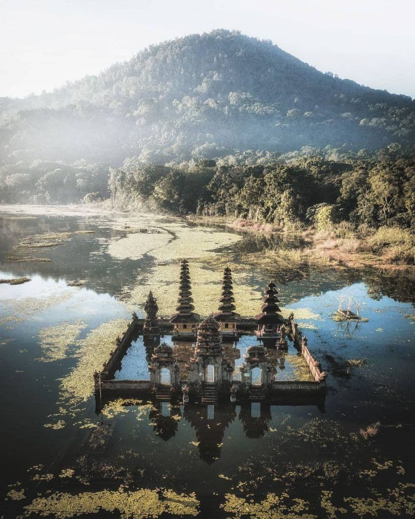 Lake Tamblingan rainforest view with Pura Ulun Danu Tamblingan temple on the water