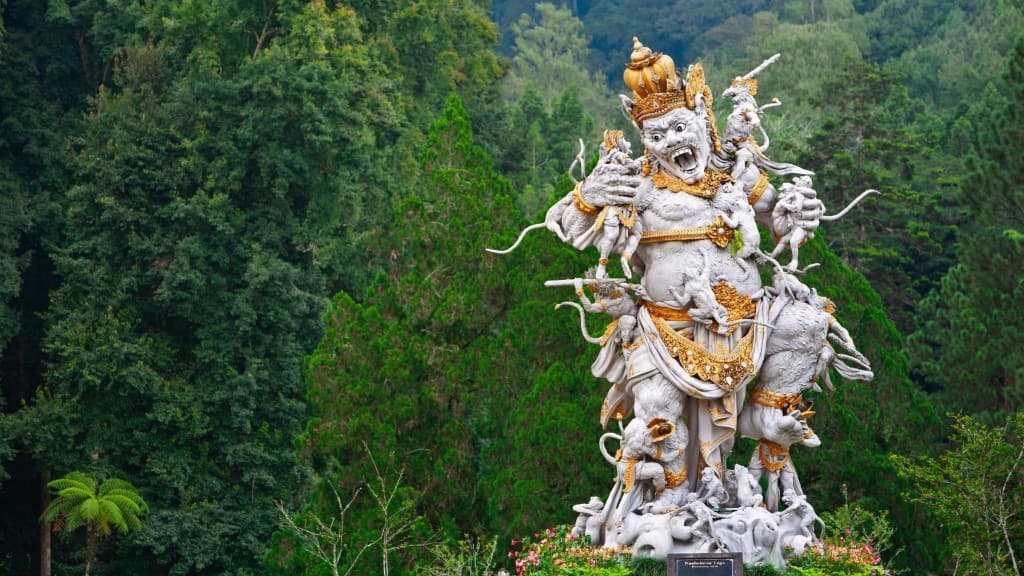 Kumbhakarna Laga statue at Bedugul Botanical Garden surrounded by rainforest