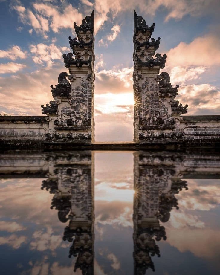 Balinese temple gates reflection at sunrise — scenic highland Bali motorcycle tour