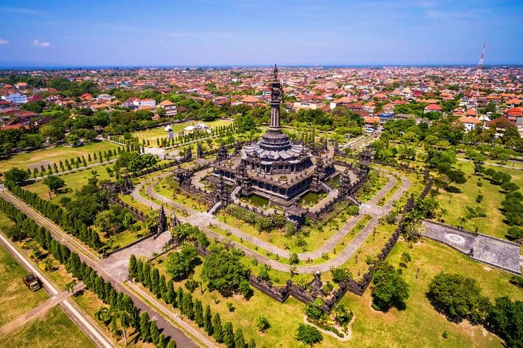 Bajra Sandhi Monument Denpasar aerial view with park and city skyline, Bali