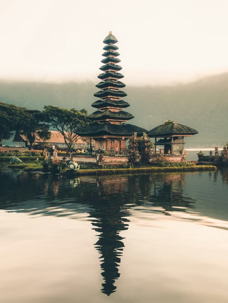 Pura Ulun Danu Bratan water temple on Lake Bratan with misty mountains, Kintamani Highlands tour Bali
