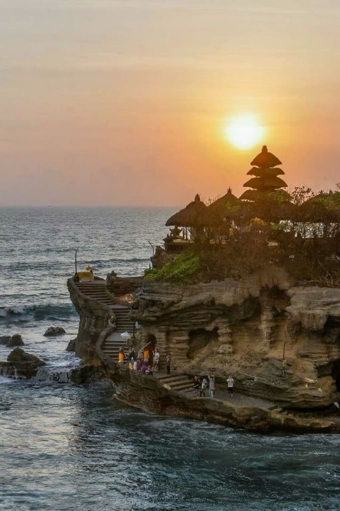 Tanah Lot Temple at sunset with golden light over the Indian Ocean, Bali